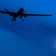 An unmanned U.S. Predator drone flies over Kandahar Air Field, southern Afghanistan, on a moon-lit night.
